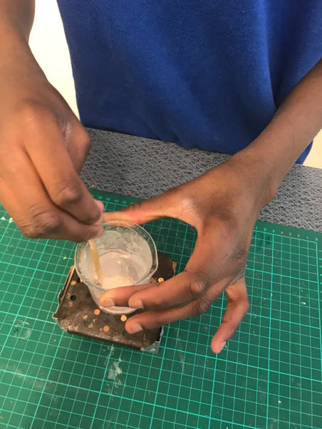 Student mixes starch in cup